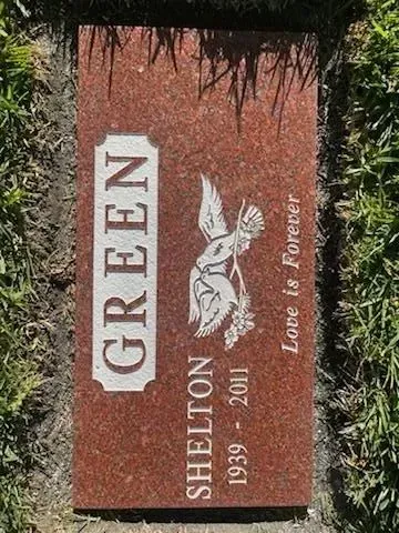 Red granite tombstone with the name 