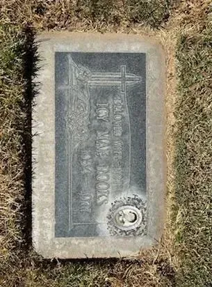 Gravestone of Toy Mae Brooks, with an ornate cross design.