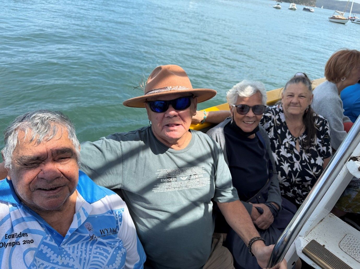 A group of people are sitting on a boat in the water.