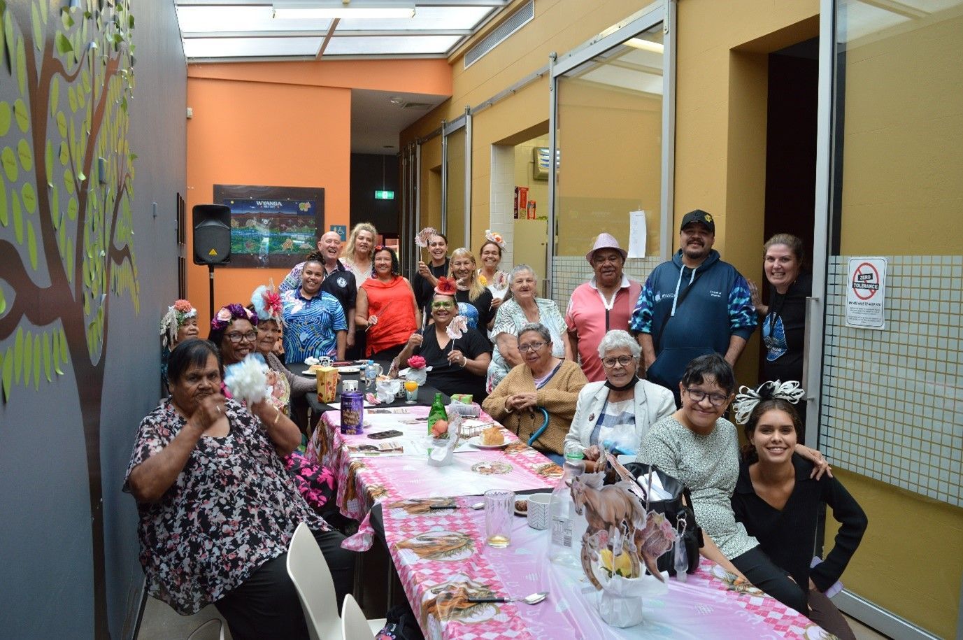 A group of people are sitting around a long table.
