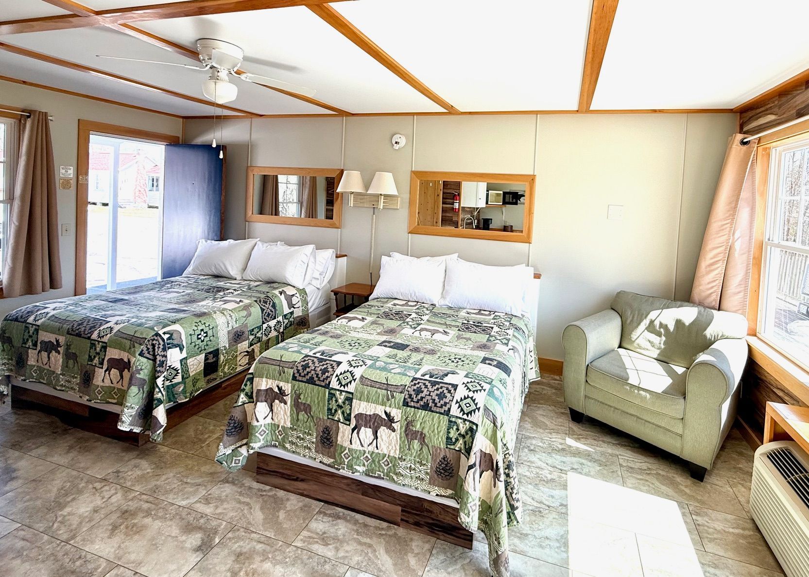 A hotel room with two beds and a chair