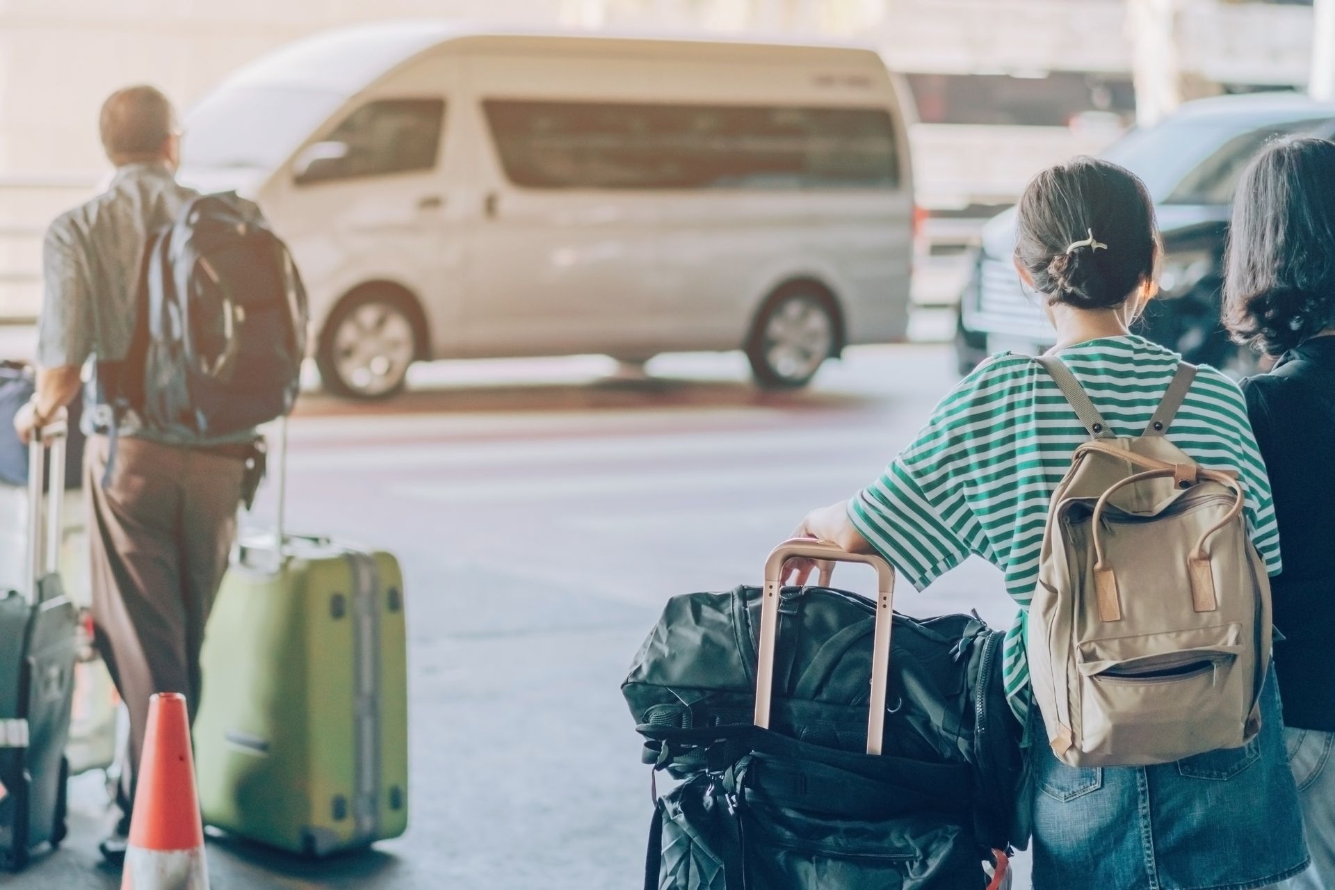 A group of people are walking with luggage at an airport.