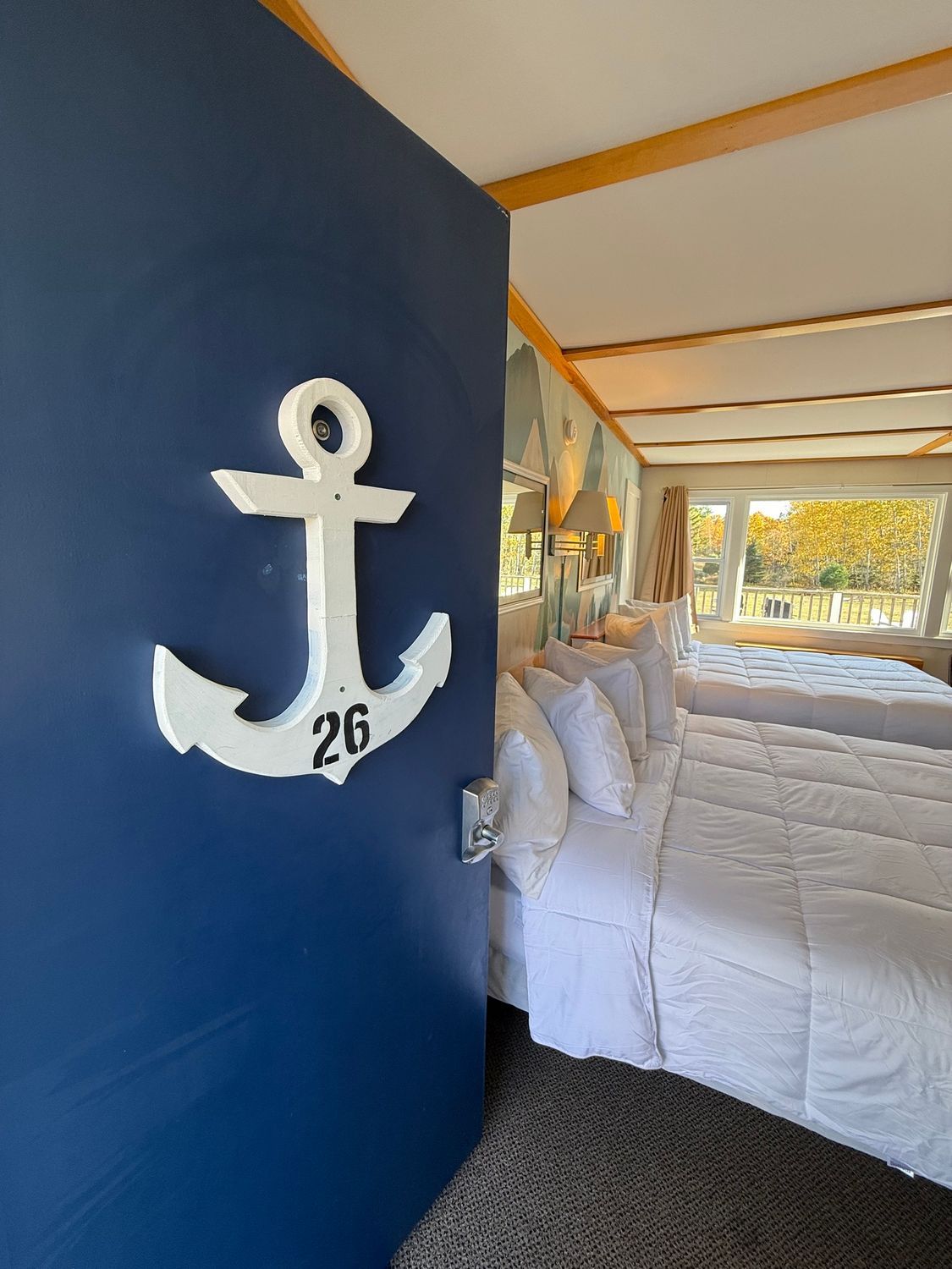 A black lantern is hanging on the side of a white house.