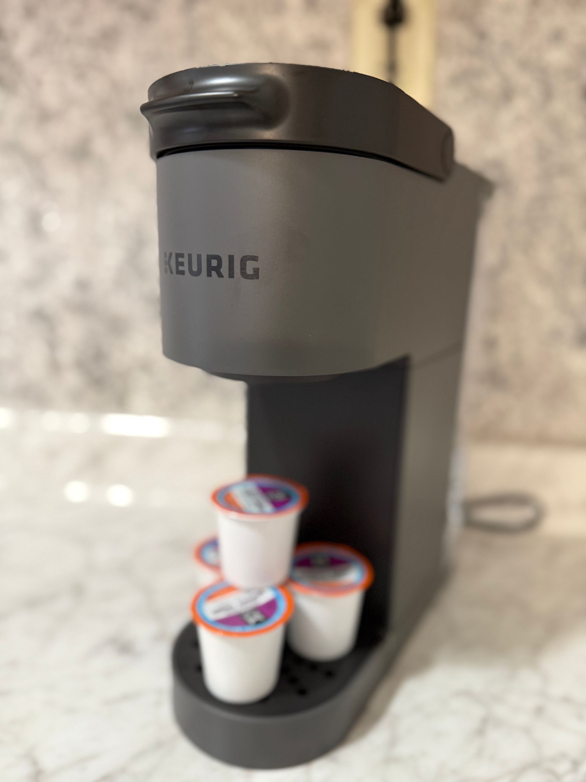 A keurig coffee maker with four cups in it