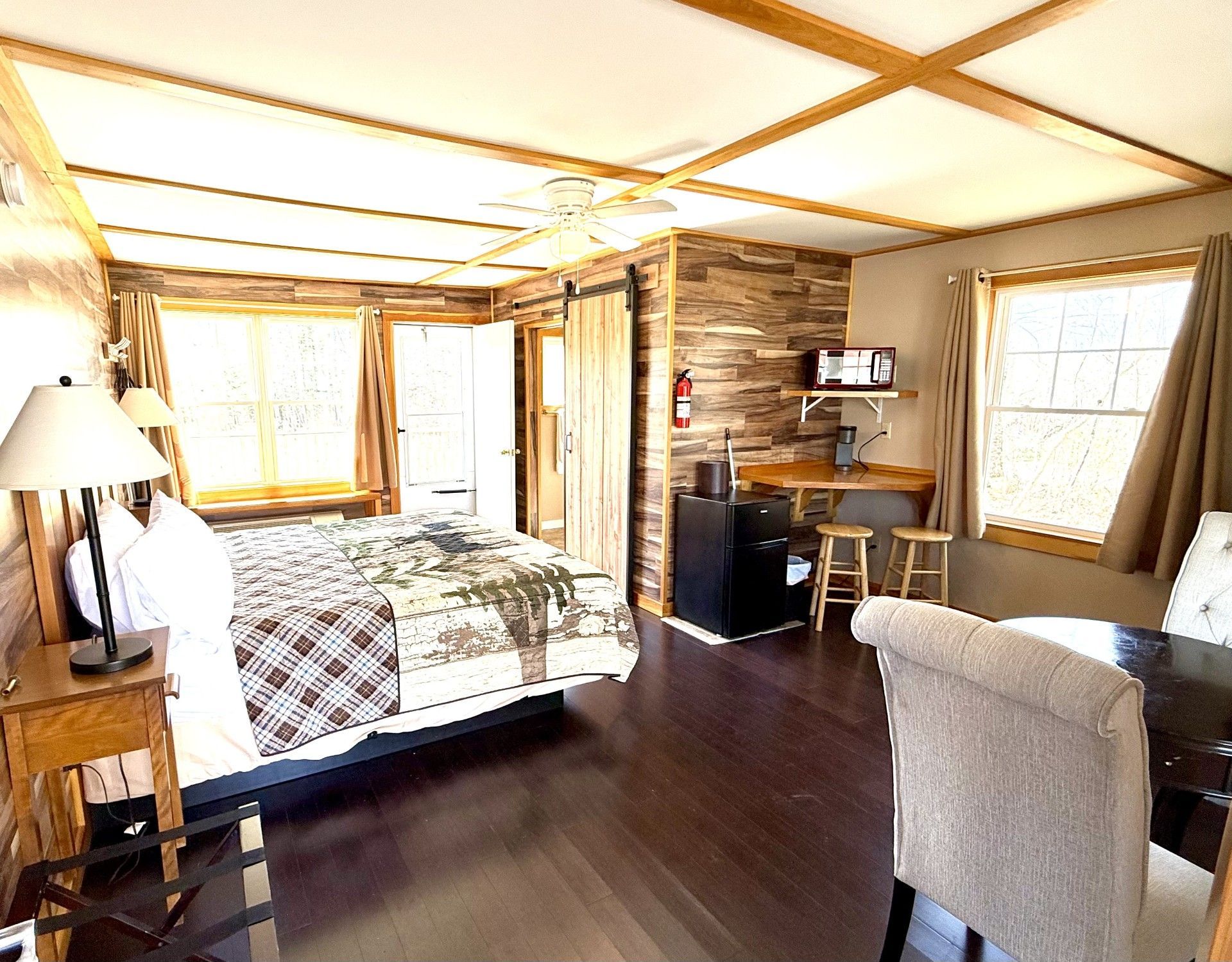 A bedroom with a king size bed and a desk