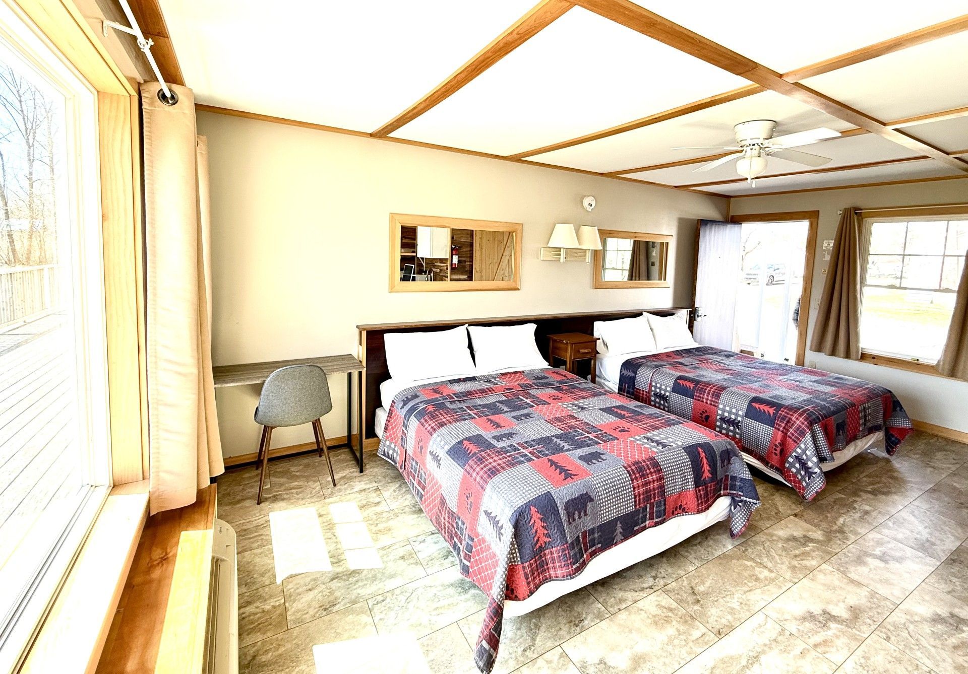 A hotel room with two beds and a desk