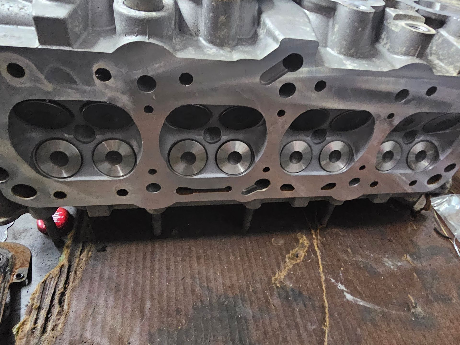 Close-up of a machined engine cylinder head showing valve seats and ports.