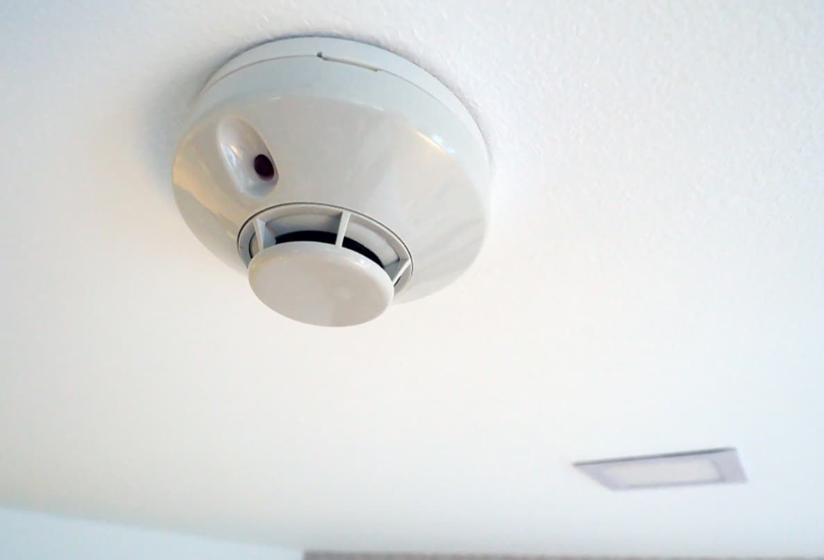A Smoke Detector Is Mounted To The Ceiling Of A Room — Mozzlec Electrical In Urangan, QLD