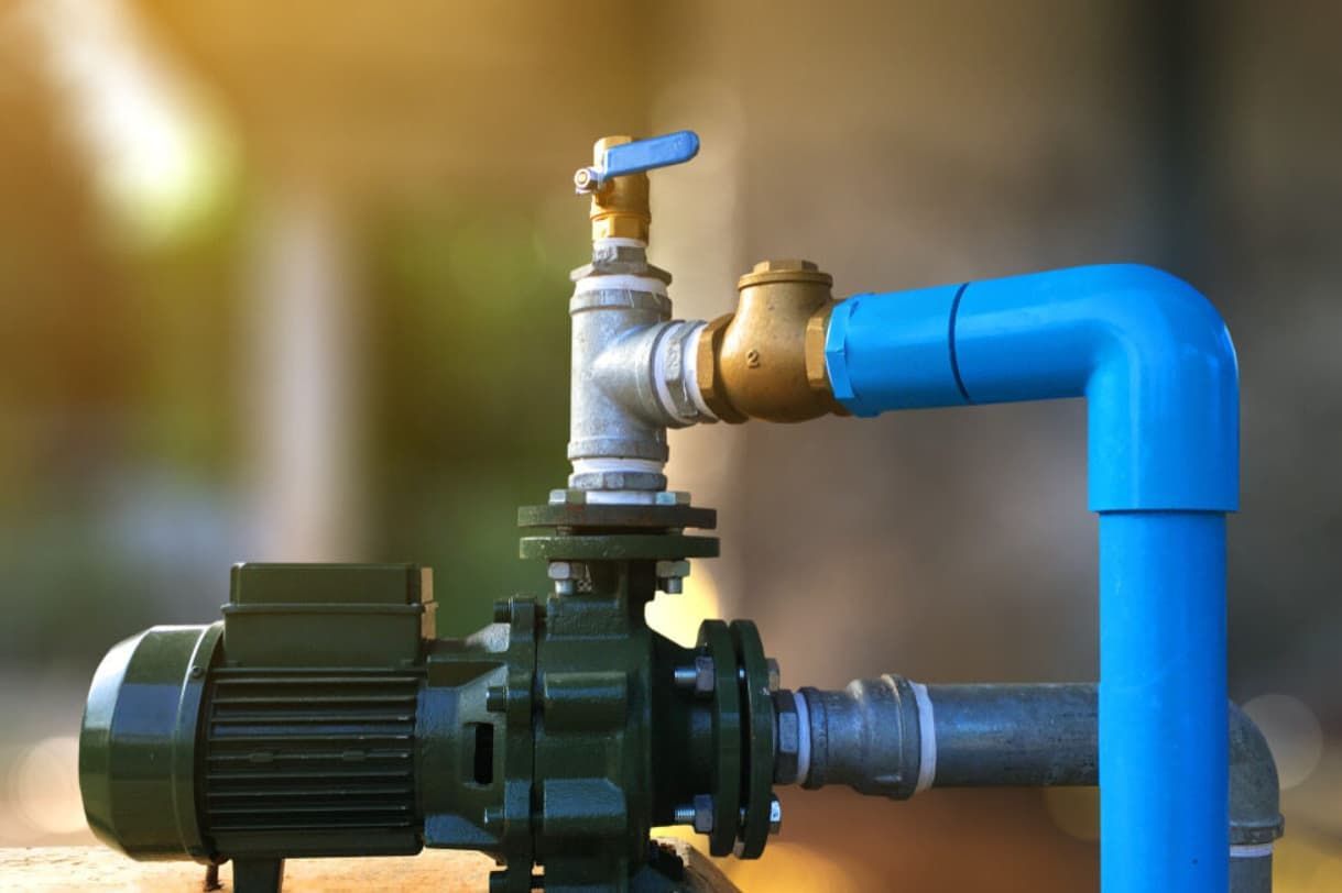A Close Up Of A Water Pump With A Blue Pipe Attached To It — Mozzlec Electrical In Urangan, QLD