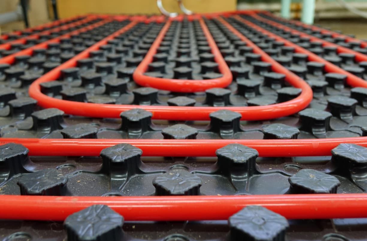 A Close Up Of A Red And Black Underfloor Heating System — Mozzlec Electrical In Urangan, QLD