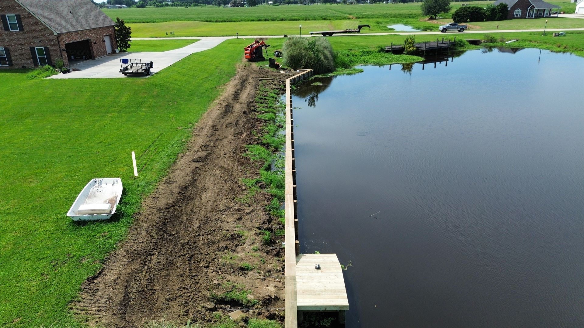 An aerial view of a house next to a body of water.