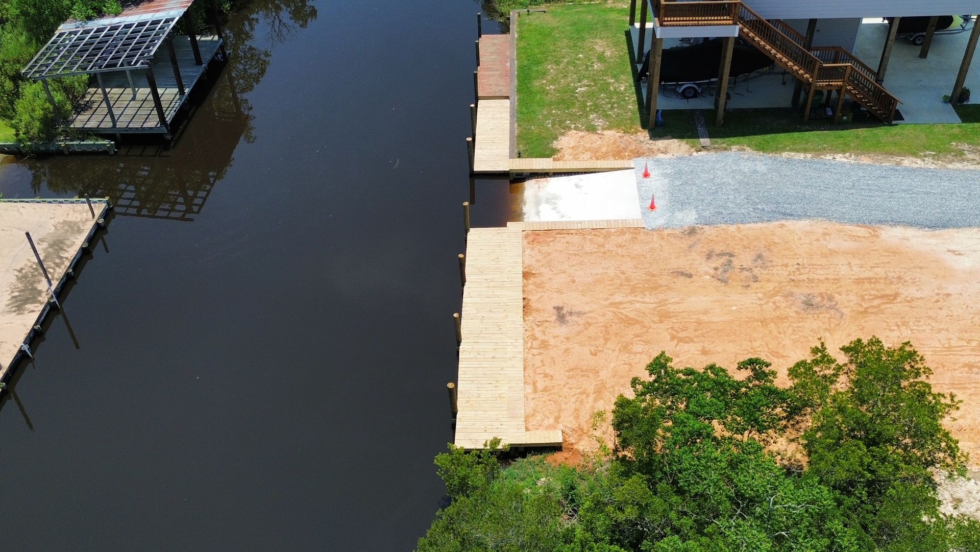 An aerial view of a house next to a body of water.