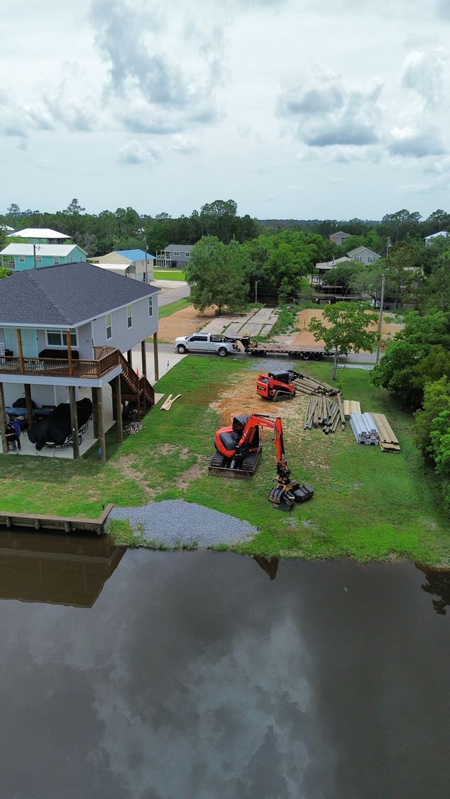 An aerial view of a house next to a body of water.