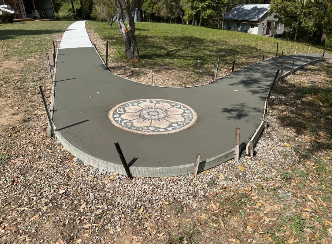 A Concrete Walkway With a Mosaic Design on It is Being Built — Brodie Wynter Concreting in Port Macquarie, NSW