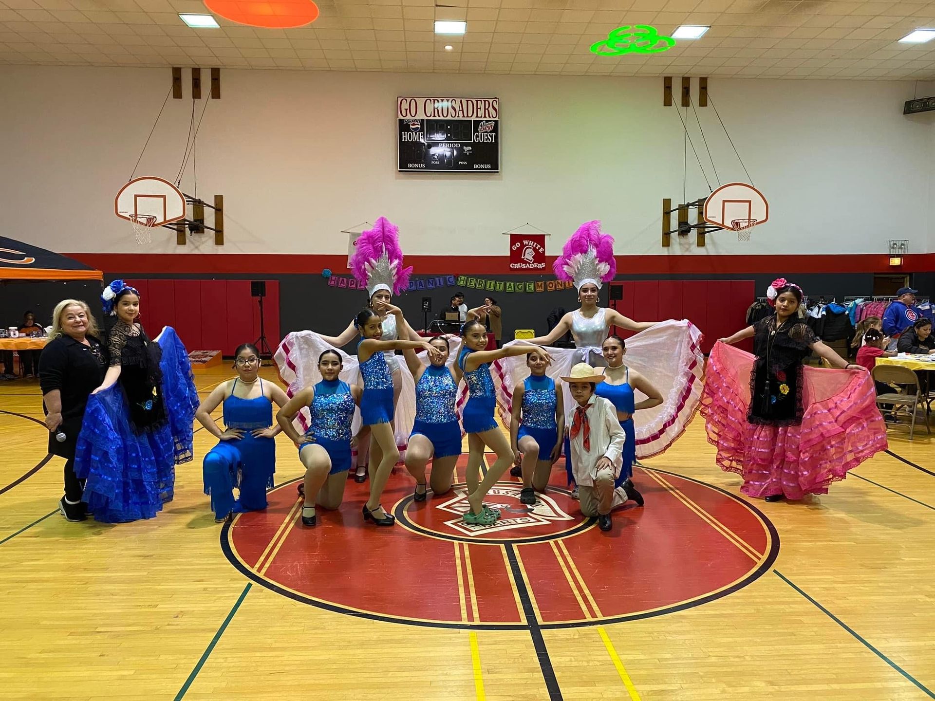 A group of women are posing for a picture in a gym.
