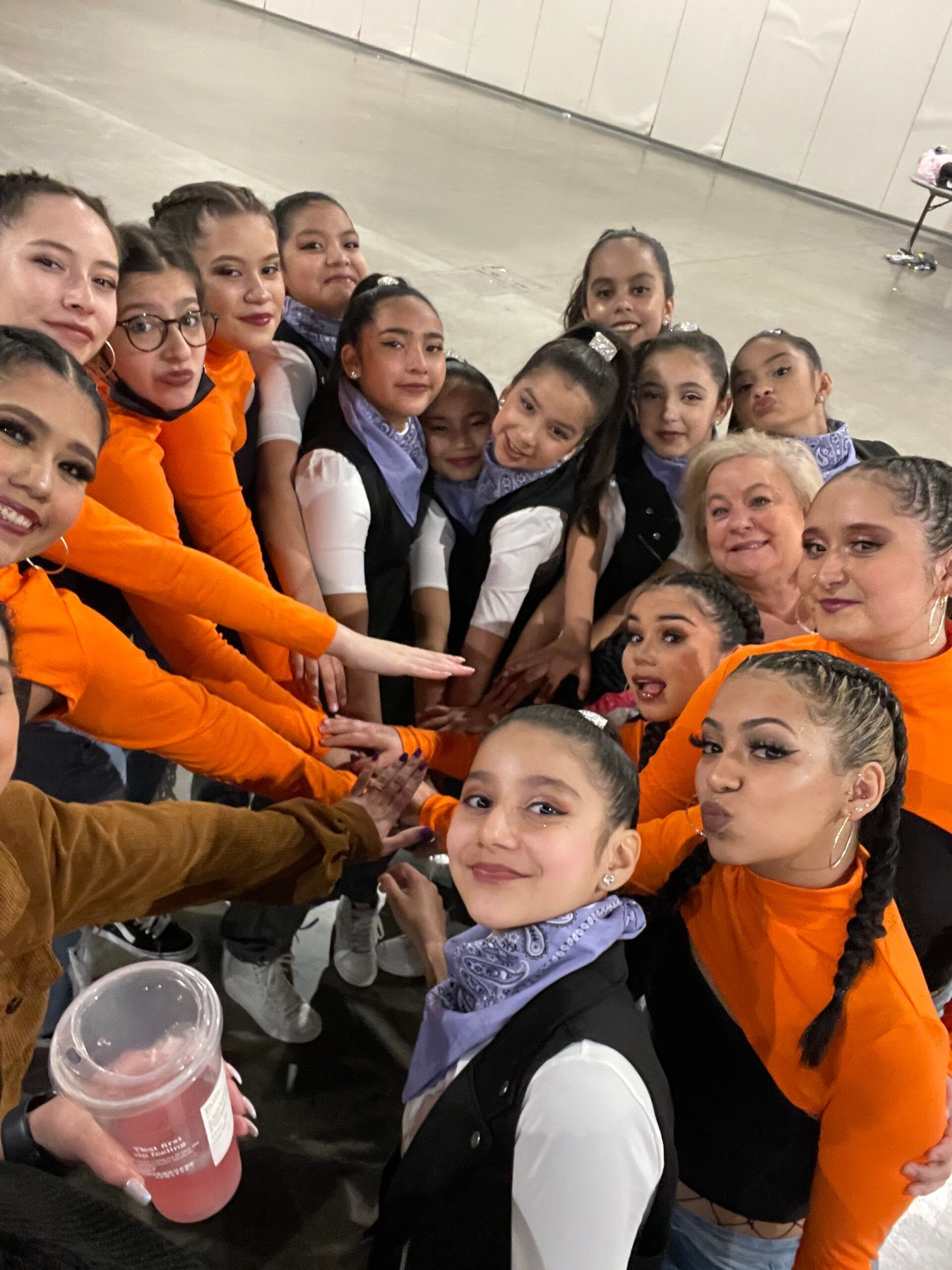 A group of young girls are posing for a picture together.