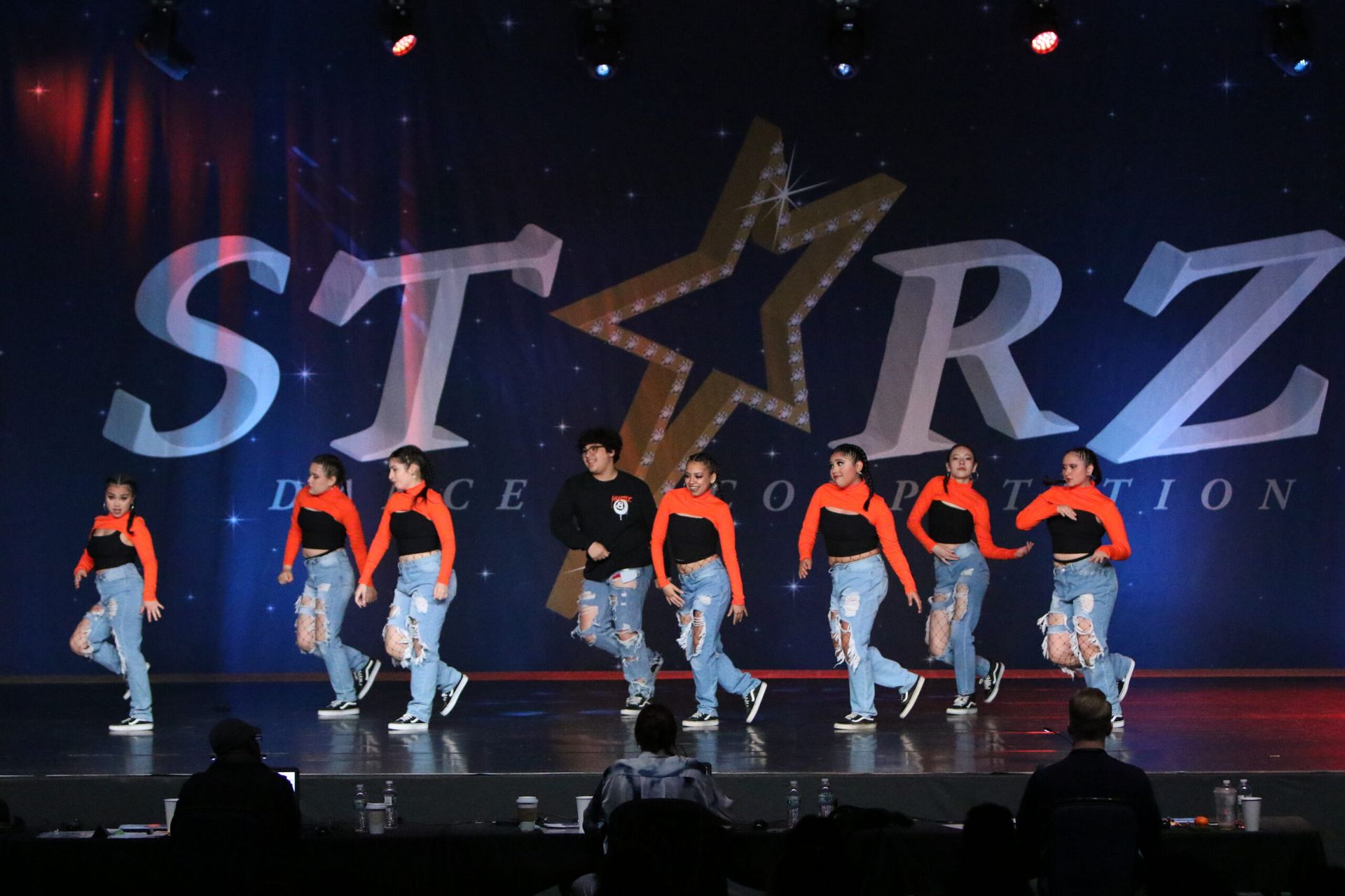 A group of people are dancing on a stage in front of a starz logo