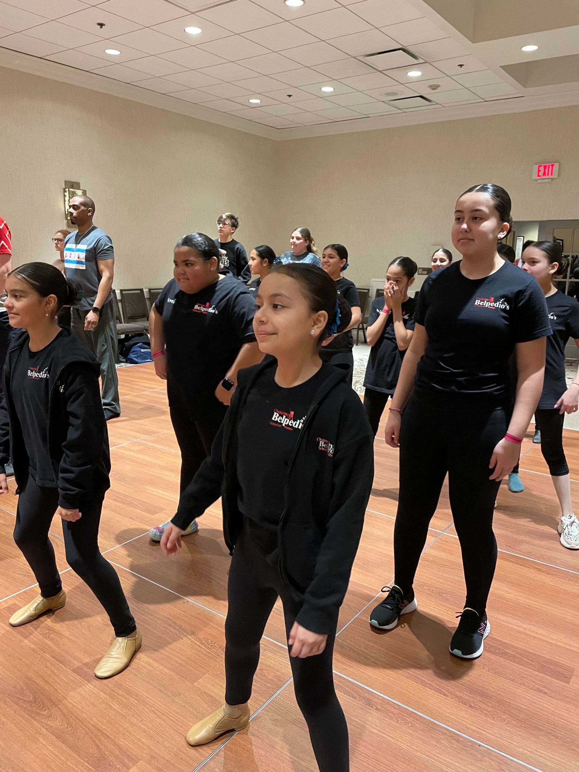 A group of young girls are dancing in a room.