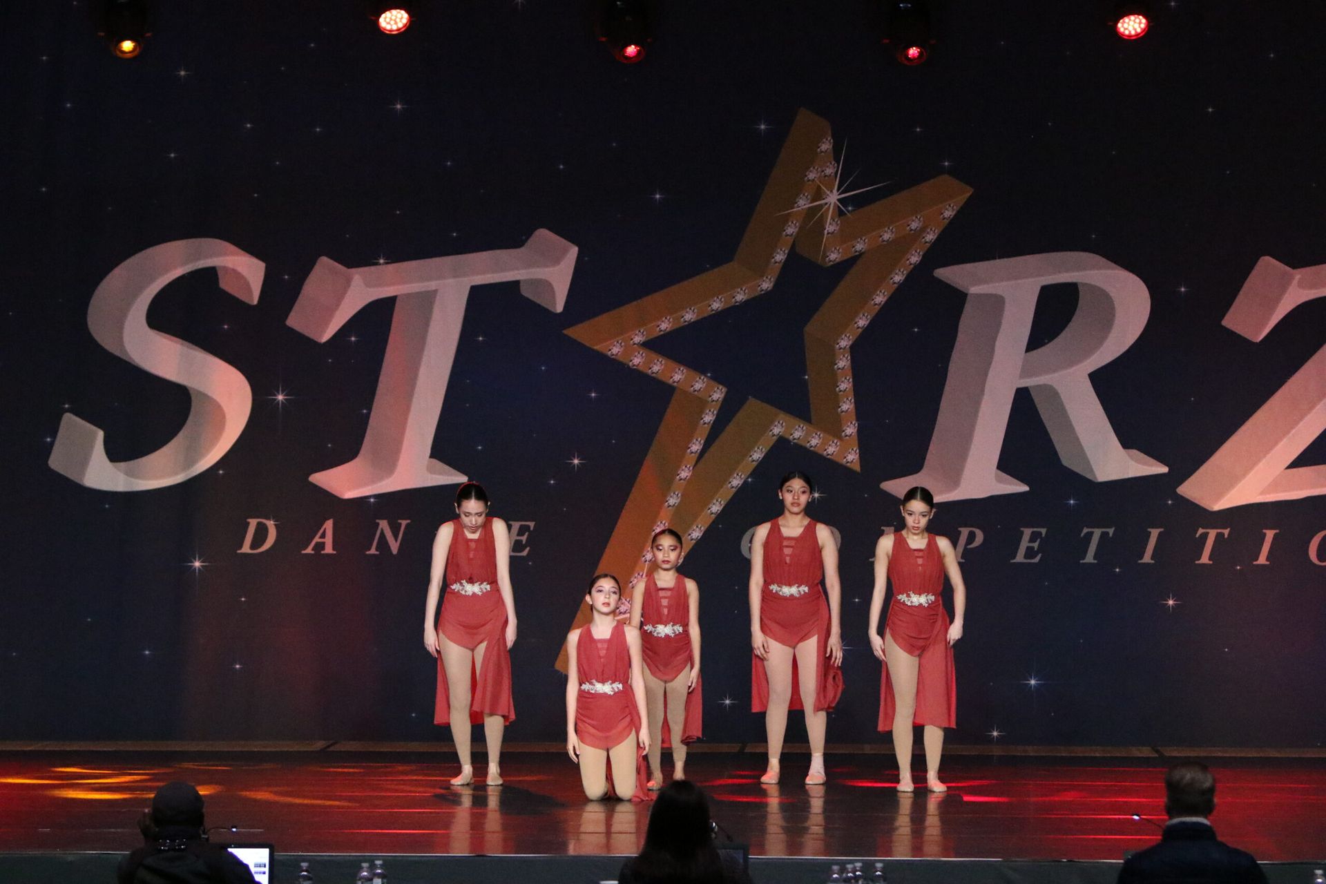 A group of dancers are on stage in front of a starz logo