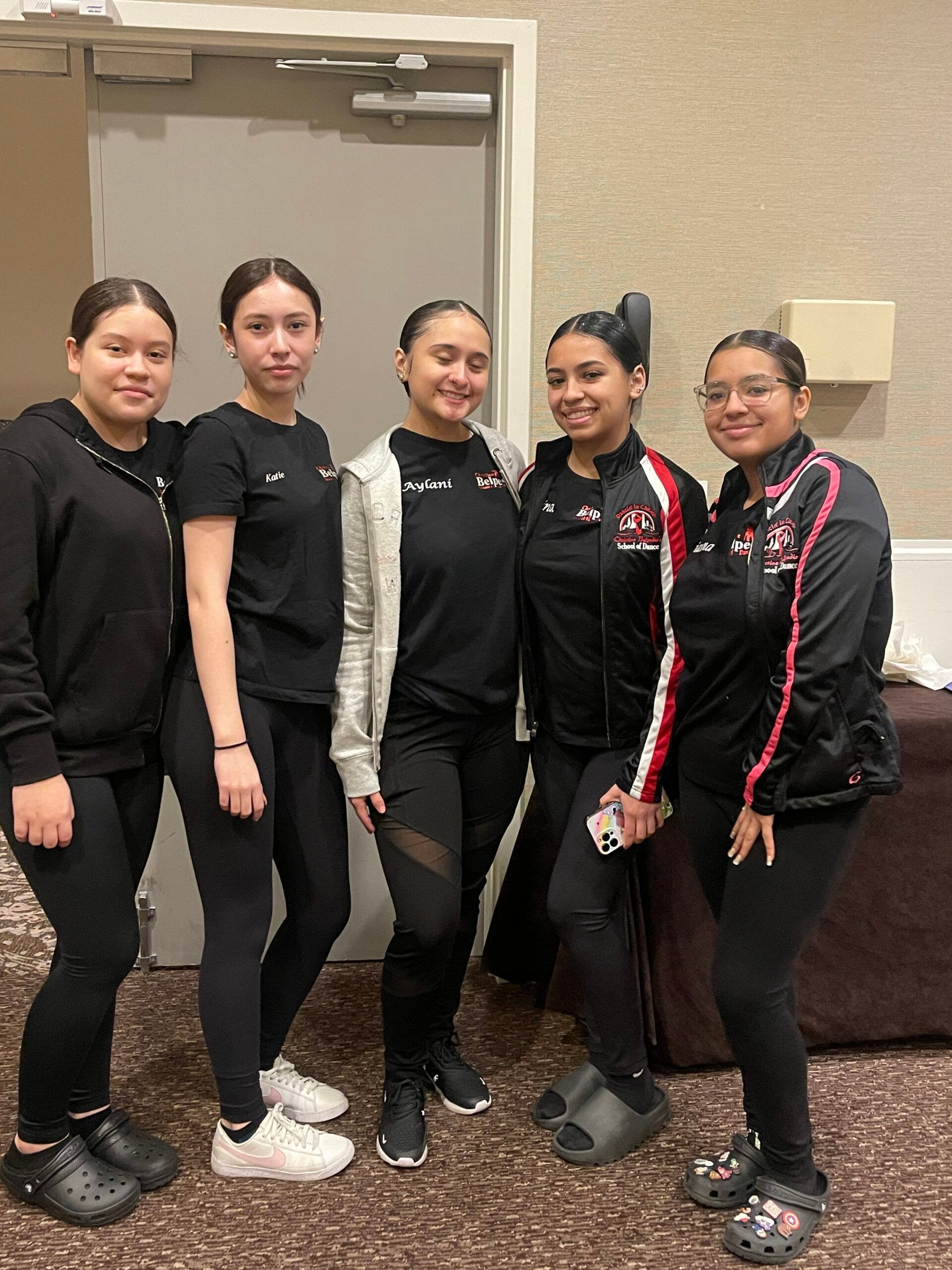 A group of young women are posing for a picture together.