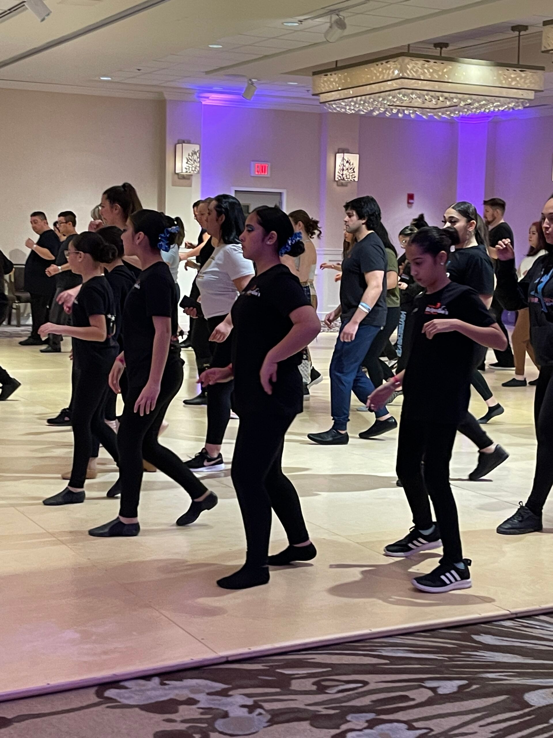 A group of people are dancing in a room.