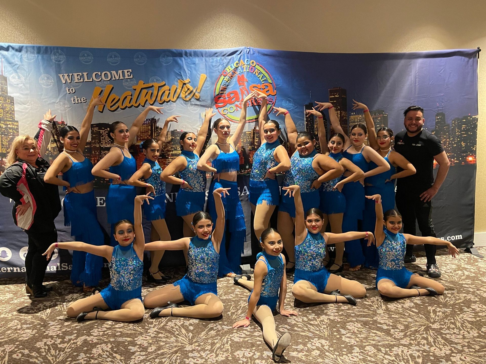 A group of young girls are posing for a picture.