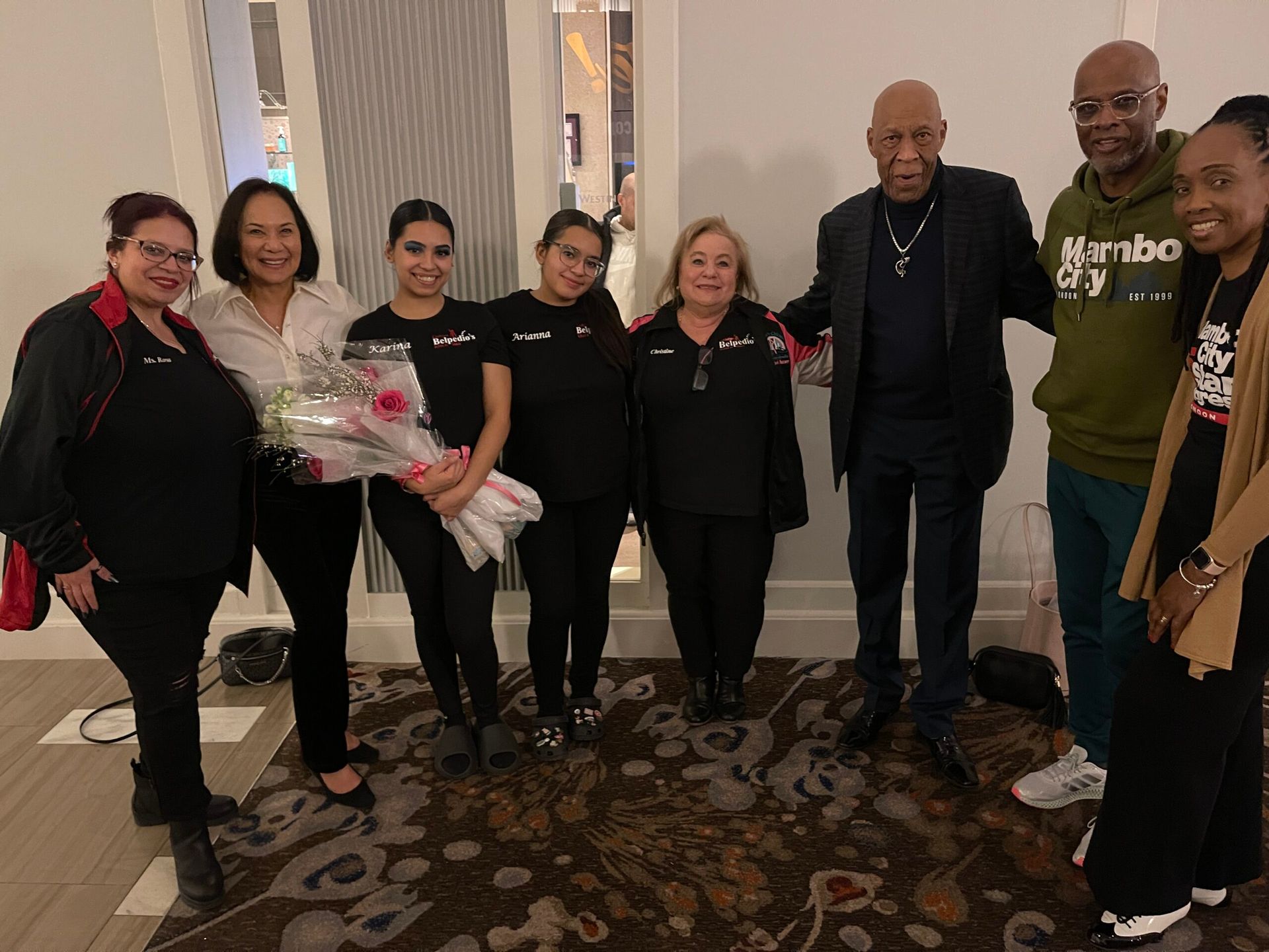A group of people are posing for a picture in a room.