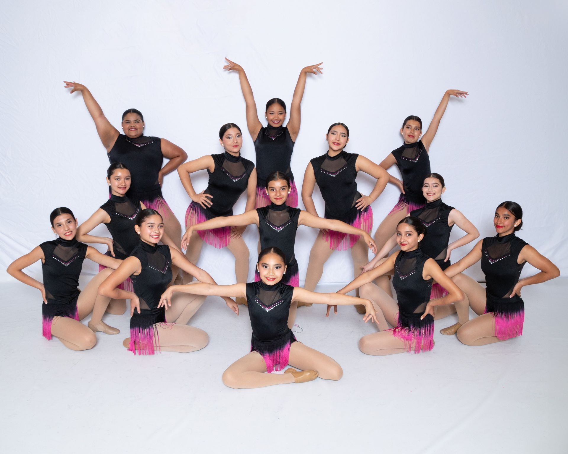 A group of young dancers are posing for a picture.