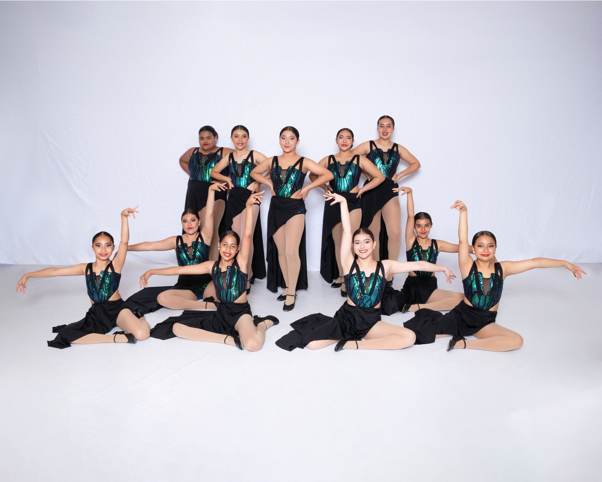 A group of young dancers are posing for a picture.