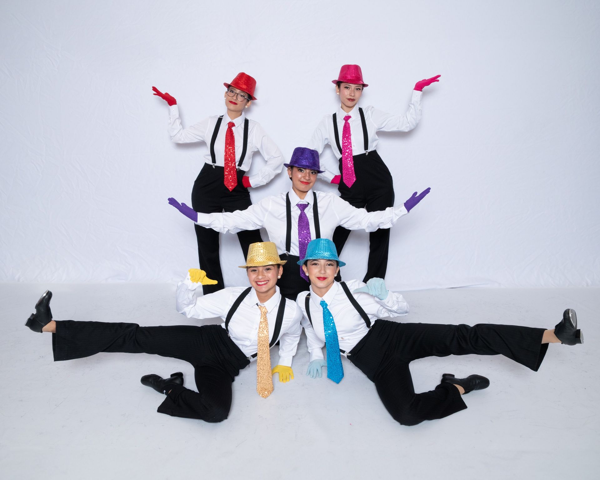 A group of people wearing hats and ties are posing for a picture