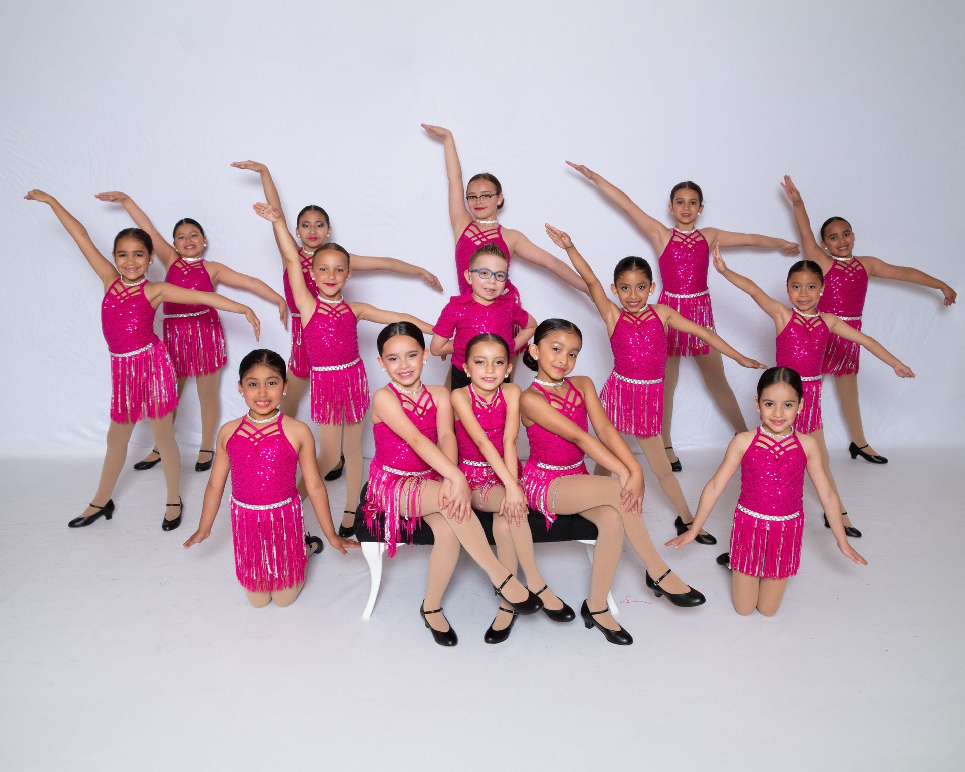 A group of young dancers are posing for a picture in a black and white photo.