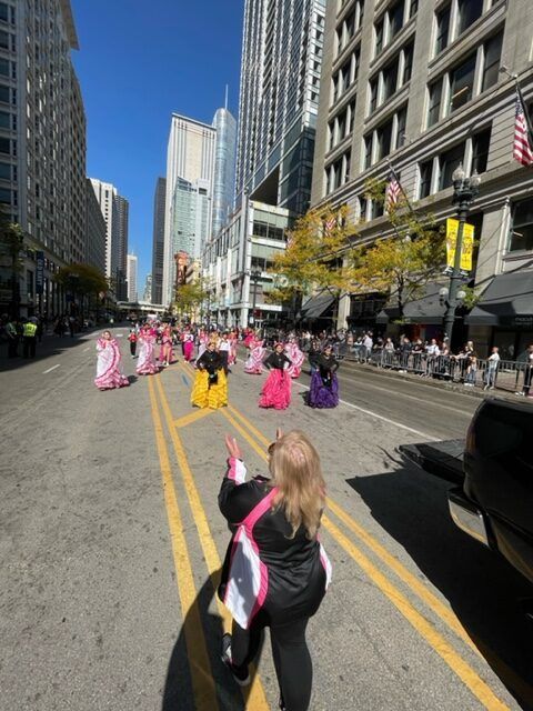 A group of people are walking down a city street