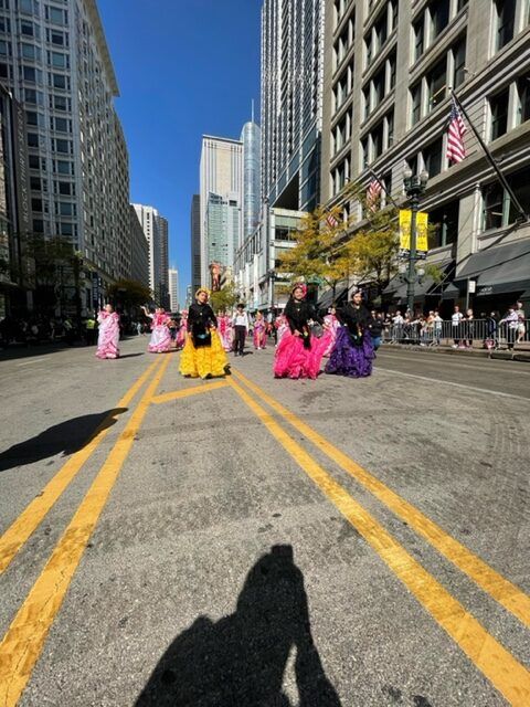 A group of people are walking down a city street