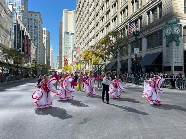 A group of people are marching down a city street