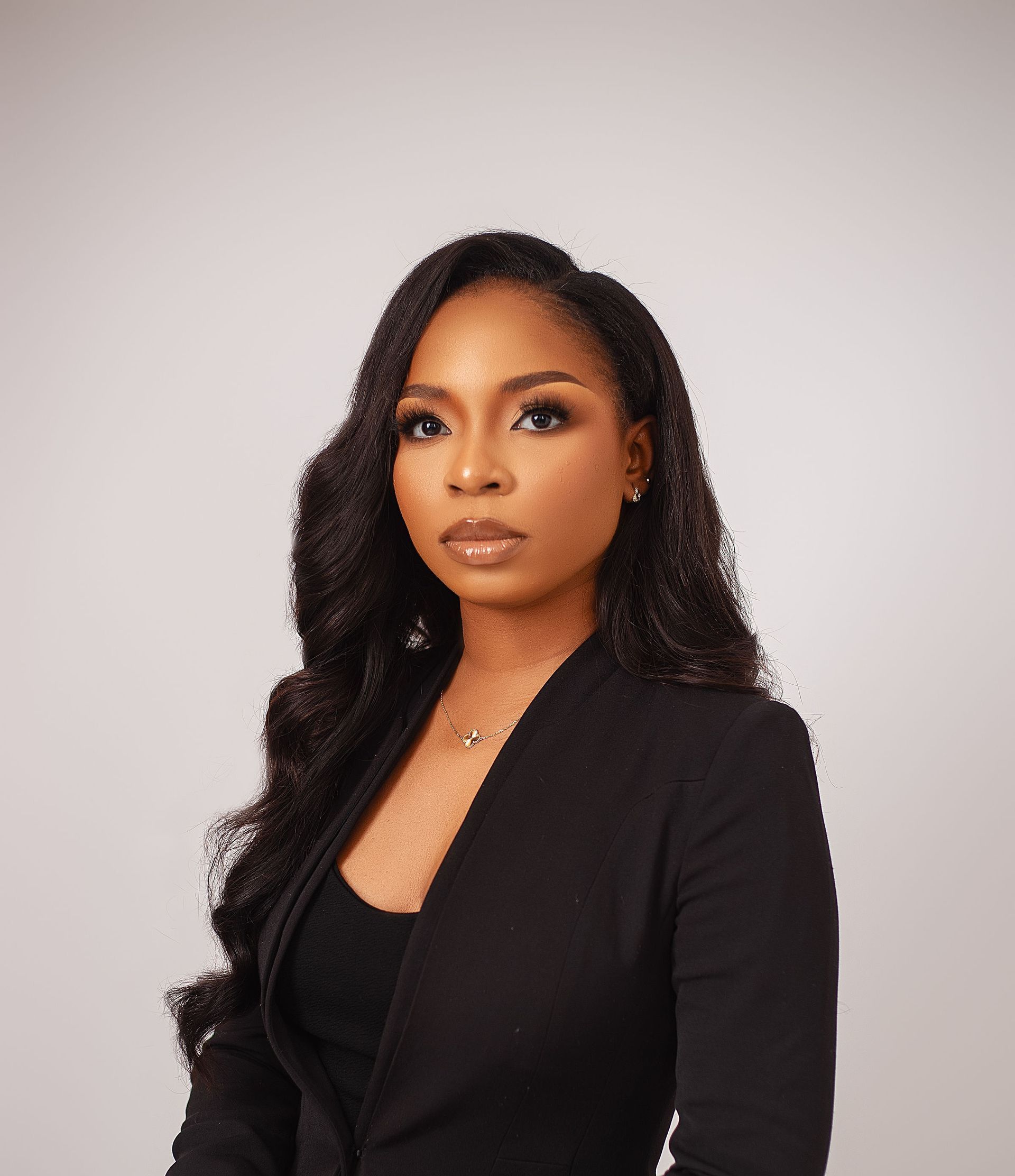 A woman wearing glasses and a black shirt is posing for a picture.