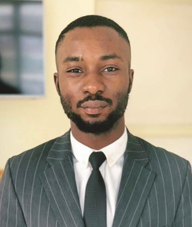 A man with a beard is wearing a suit and tie.