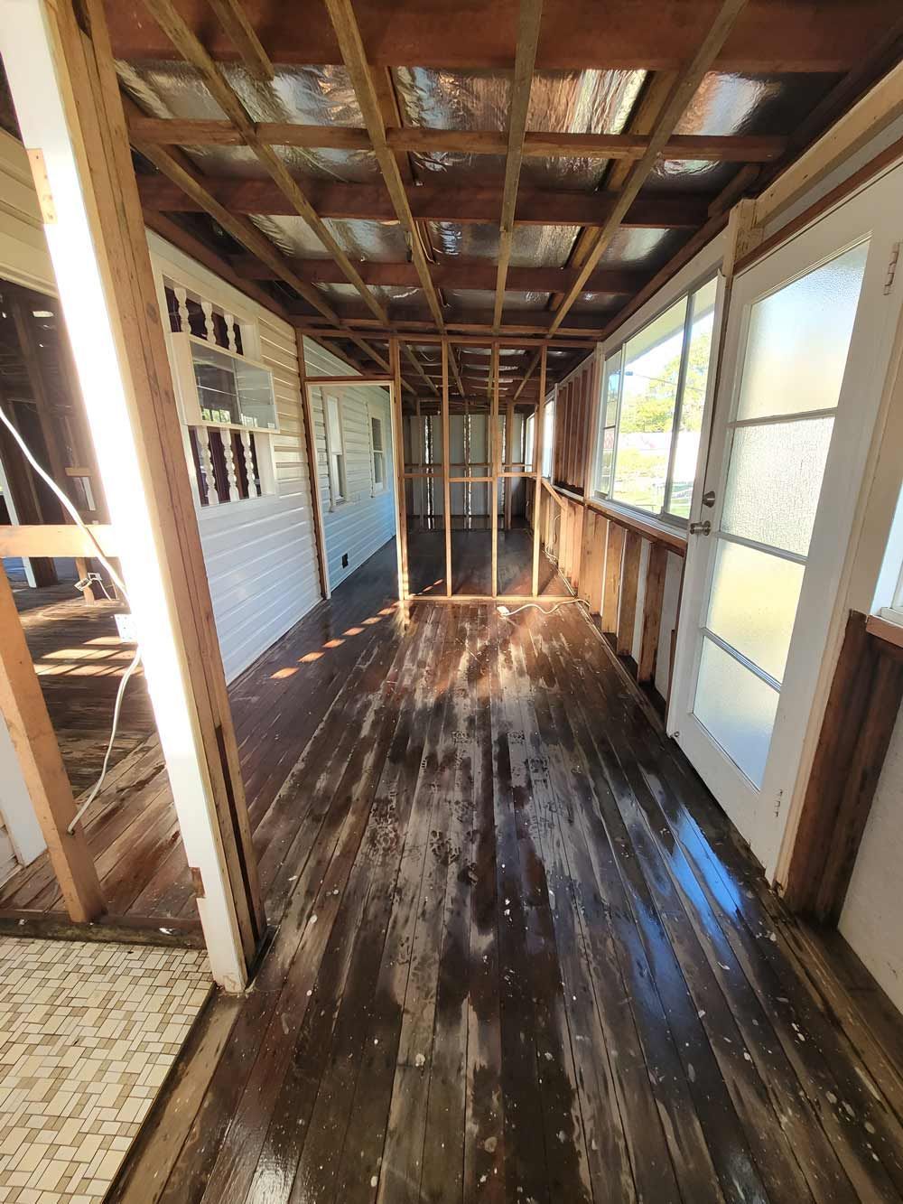 A Long Hallway With A Wooden Floor And A Lot Of Windows Demolition — Accredited Asbestos Removers in Casino, NSW