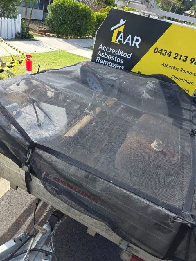 A Trailer Covered With a Black Net — Accredited Asbestos Removers in Ballina, NSW