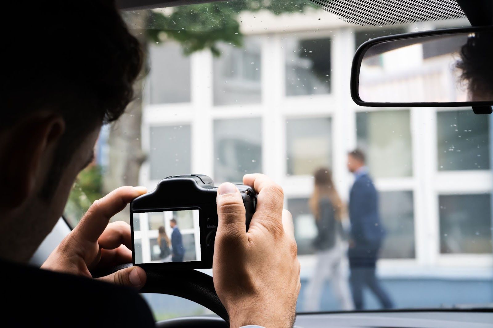 Private detective near me using a camera during vehicle surveillance on a cheating spouse case.