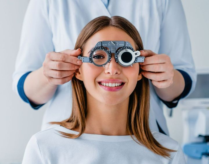 Un oftalmólogo examina los ojos de una mujer.