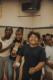 A group of children are posing for a picture together in a room.