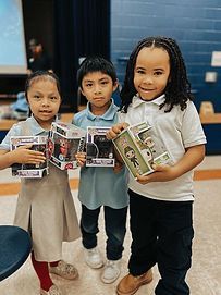 Three children are standing next to each other holding funko pop toys.