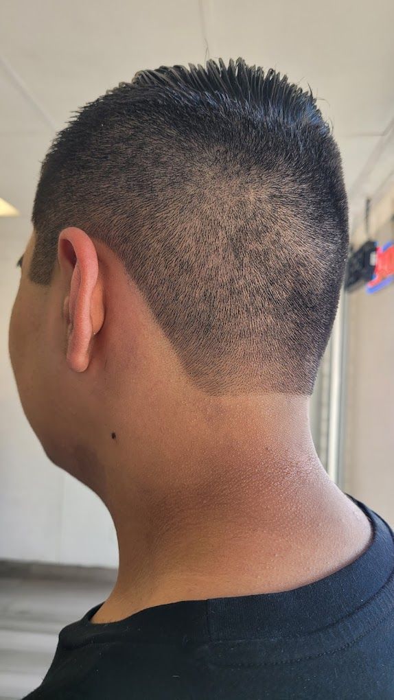 The back of a man 's head with a mohawk hairstyle.