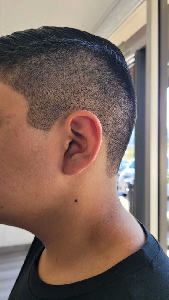 A close up of a person 's ear and neck.