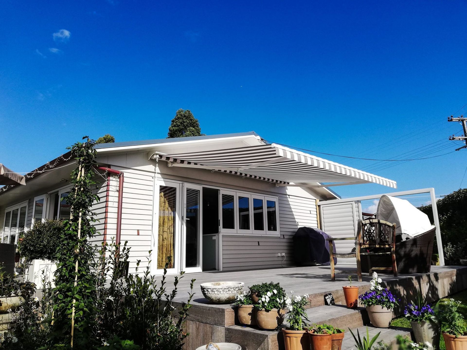 A white house with a white awning on the roof