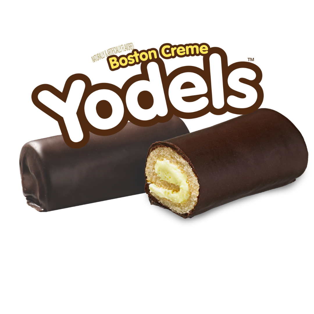 A yodels boston creme roll with a slice taken out of it