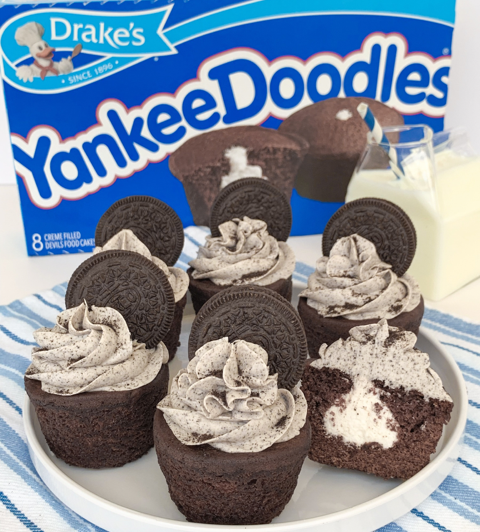 A box of yankee doodle cupcakes with cookies and cream frosting with a chocolate sandwich cookie