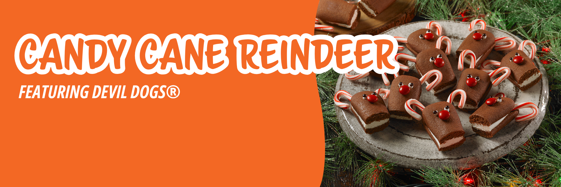 Orange banner promoting small chocolate cream-filled cakes decorated as reindeer with candy cane antlers and red candy noses on a grey plate.