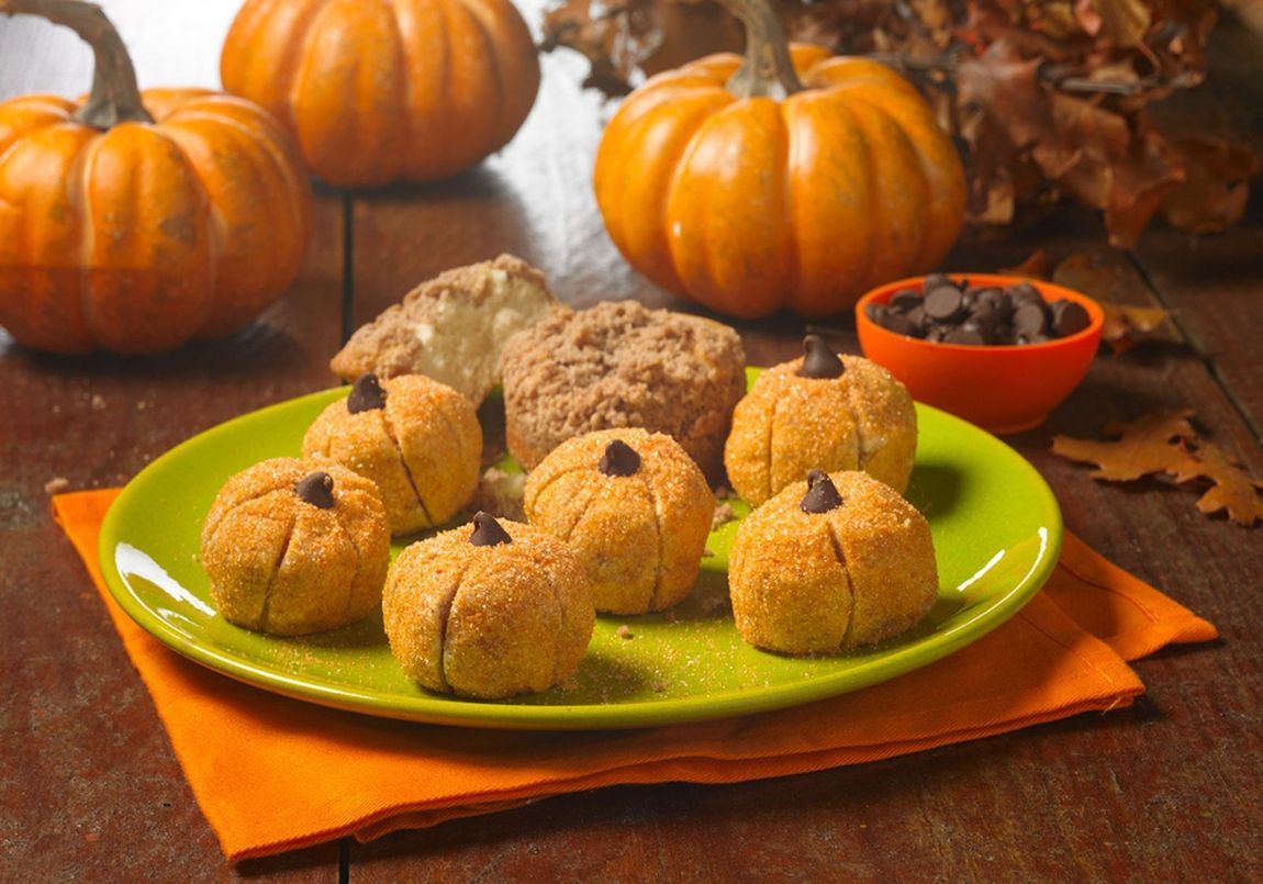 pumpkin truffles on a green plate with an orange napkin