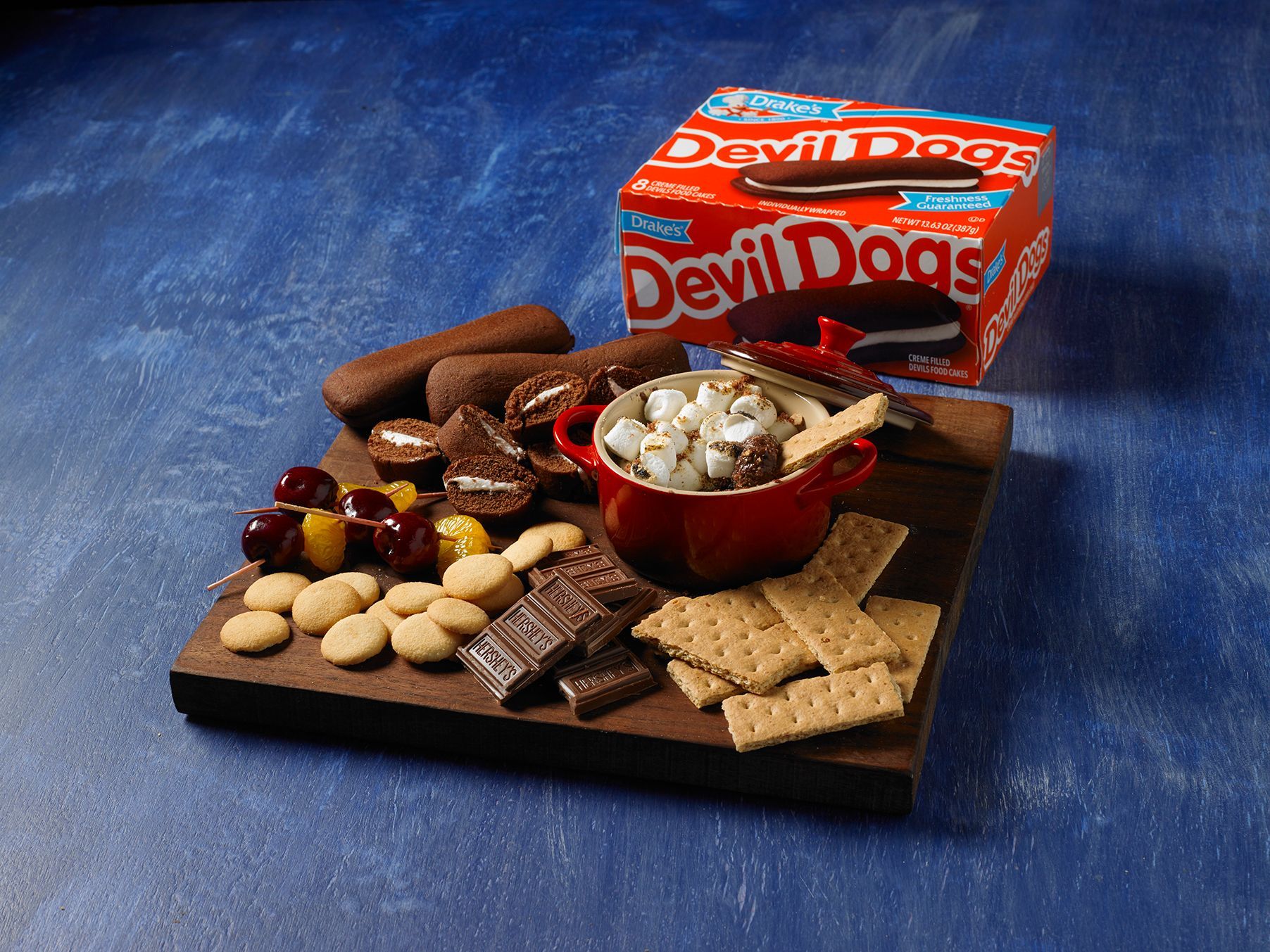 A box of devil dogs sits on a wooden cutting board